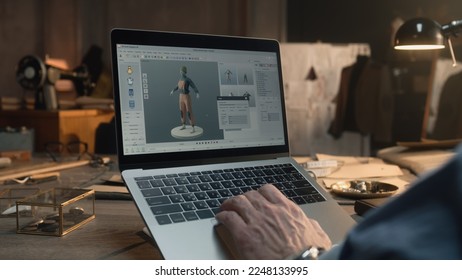 Fashion designer creates clothes and develops future wear collection in 3D modeling program. Male tailor works in luxury designer workshop or tailoring studio on laptop. Fashion concept. - Powered by Shutterstock