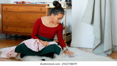 Fashion designer examining the fabric at design studio 4k - Powered by Shutterstock