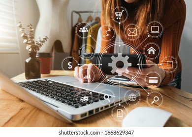 Fashion designer holding mobile phone and using laptop with digital tablet computer in modern studio with VR icon diagram
 - Powered by Shutterstock