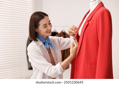 Fashion designer with needles working in workshop - Powered by Shutterstock