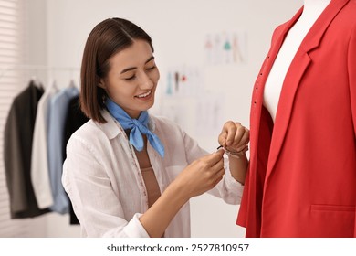 Fashion designer with needles working in workshop - Powered by Shutterstock