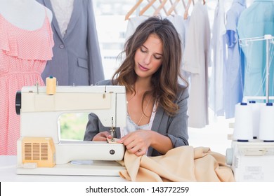 Fashion designer sewing with sewing machine