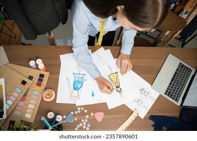 Fashion designer is sketching a model of a dress. - Powered by Shutterstock