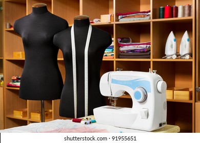 Fashion designer studio with dressmakers professional equipment: mannequin, cloth, sewing machine, irons, Patterns of clothing