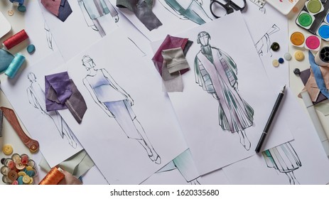Fashion designer stylish drawings sketches textile fabric material Costume. Designer creative workshop studio.                         