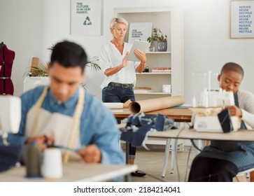 Fashion Designer, Tailor And Manager Reading Online Orders On A Tablet In Her Startup Workshop. Small Business .clothing Manufacturer Managing Employees, Staff And Workers In Her Sewing Company