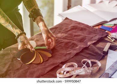 Fashion designer tattooed girl choosing material - Shutterstock ID 599950847
