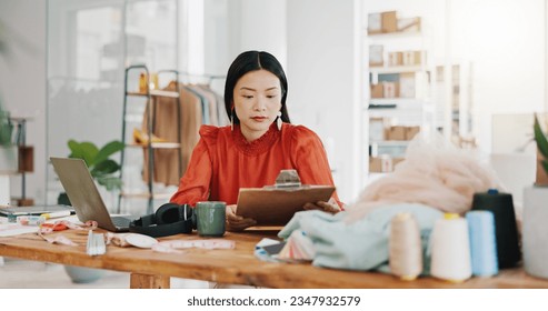 Fashion designer woman planning her small business startup with checklist in textile, tailor and fabric check at office studio. Quality control, manufacturing and asian person coffee for productivity - Powered by Shutterstock