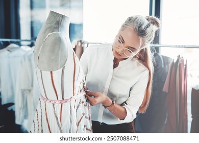 Fashion designer, woman and tailor workshop with clothes design and measurement creative studio. Sustainable brand, eco friendly fabric and personal shopper in boutique with small business owner - Powered by Shutterstock