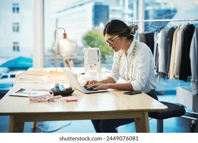 Fashion designer, woman and typing on laptop in shop for email, project or online order of fabric in creative startup. Serious tailor, computer and small business for clothes or .textile in boutique - Powered by Shutterstock