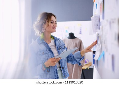 Fashion designer woman working on her designs in the studio - Shutterstock ID 1113918320