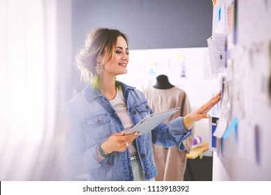 Fashion designer woman working on her designs in the studio - Shutterstock ID 1113918392