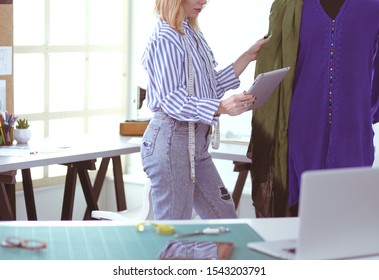 Fashion designer working on her designs in the studio - Shutterstock ID 1543203791