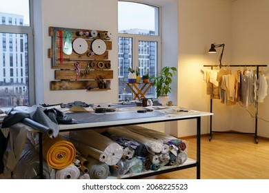 Fashion designer working studio interior with workplace table, fabric materials and sewing patterns for clothes designing, tailoring. Atelier workshop space. Small business and self employment concept - Shutterstock ID 2068225523