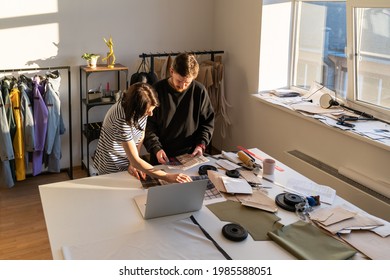 Fashion designers team choose colors and material for new collection. Dressmakers work on clothes creation using swatches pallet. Garment industry and teamwork in design studio. Small business concept