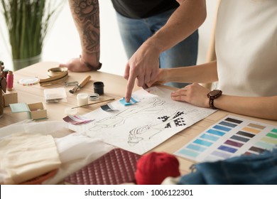 Fashion Designers Team Choosing Colors For New Collection Discussing Sketches, Dressmakers Working On Clothes Creation Using Swatches Pallet, Teamwork In Design Studio Concept, Close Up View