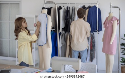 Fashion designers use pins and sewing thread to prepare patterns for cutting and sewing into simple garments. At a crafted design studio, the process of creating matching pieces for the collection. - Powered by Shutterstock