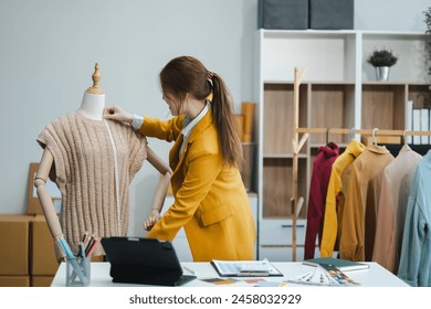 Fashion designers at work. beautiful young woman working in fashion design studio. - Powered by Shutterstock