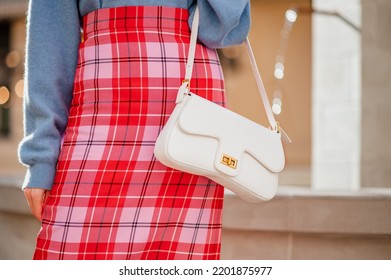 Fashion Details Of Elegant Female Outfit With Trendy White Faux Leather Bag,checkered Red, Pink Skirt. Street Style. Copy, Empty Space For Text

