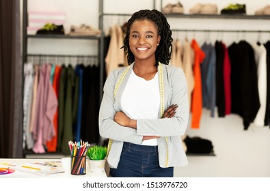 Fashion Entrepreneur. Happy Black Clothing Designer Standing Posing In Own Dressmaking Atelier. Copy Space