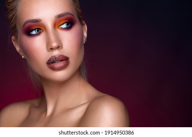 Fashion fashionable beautiful woman bright colored makeup. Glamour passion multi-colored makeup. Close-up portrait colourful. style, abstract colorful makeup, artistic design. Black background