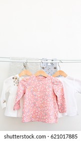 Fashion female child's (baby) clothes hanging on a clothesline isolated on white background/ Baby wear set/ Close-up. - Shutterstock ID 621017885