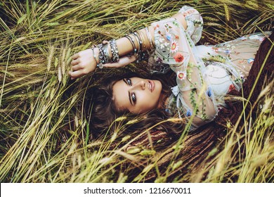 Fashion Female Model Posing In A Field. Contemporary Bohemian Style.