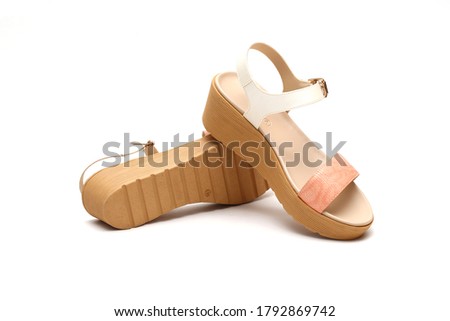 Fashion female and woman leather sandals or wedges sandals with solid white background