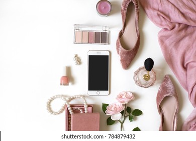 Fashion Feminine Blogger Concept. Minimal Set Of Woman Accessories On White Background. Still Life Of Pink Objects: Rose, Cosmetics, Perfume, Jewellery, Shoes, Smart Phone Mockup With Empty Screen