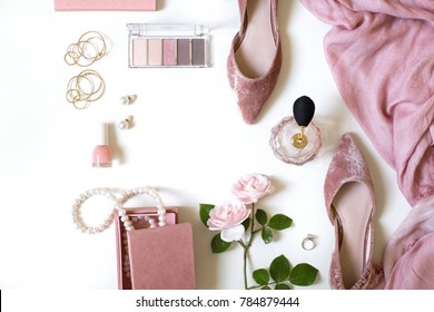 Fashion feminine blogger concept. Minimal set of woman accessories on white background. Still life of pink wedding objects: rose, cosmetics, perfume, jewellery and shoes with space for text - Shutterstock ID 784879444