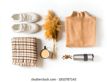 Fashion Flat Lay With Autumn And Winter Clothes - Beige Cozy Sweater, Plaid Scarf, Sneakers, Coffee And Accessories On White Background, Top View