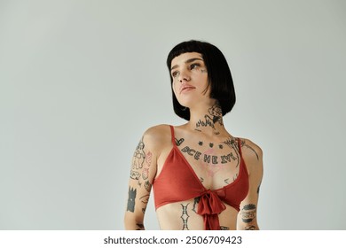 Fashion forward young woman flaunts her tattoos and stylish attire.