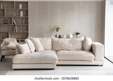 Fashion furniture inside modern light living room with white sofa, built-In bookcase with shelves, armchair, no people. Design interior ideas, furnishing store, new real-estate, rent property concept - Shutterstock ID 2078658883