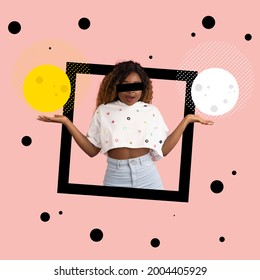 Fashion and geometry. Creative image of young african woman with white and yellow circles in black square frame over light pink background.