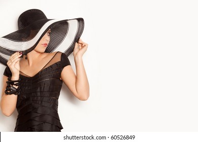 Fashion Girl In A Big Hat In The Studio