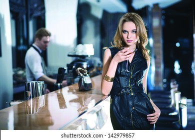 Fashion girl drinking a cocktail