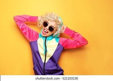 Fashion Girl In Sportswear On Yellow Background