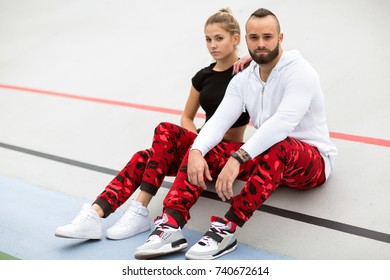 Fashion Guy With A Girl Posing In The Same Sportswear