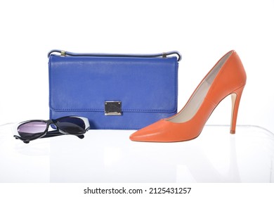 fashion high hell shoes and blue handbag  sunglasses isolated white background

