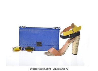 fashion high hell shoes and blue handbag  sunglasses isolated white background