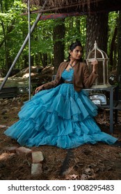 Fashion Image Of Beautiful Asian Indian Woman Wearing Blue Gown In A Junk Yard. 