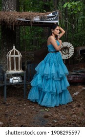 Fashion Image Of Beautiful Asian Indian Woman Wearing Blue Gown In A Junk Yard. 