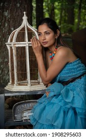 Fashion Image Of Beautiful Asian Indian Woman Wearing Blue Gown In A Junk Yard. 