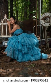 Fashion Image Of Beautiful Asian Indian Woman Wearing Blue Gown In A Junk Yard. 