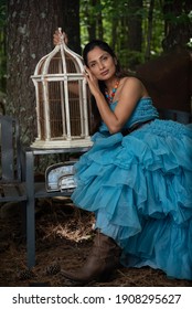 Fashion Image Of Beautiful Asian Indian Woman Wearing Blue Gown In A Junk Yard. 