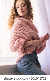 Fashion Interior Photo Of Beautiful Young Girl With Blond Curly Hair And Glowing Skin,in Casual Clothes