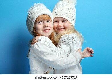 Fashion Kids Posing At Studio. The Concept Of Children's Fashion, Winter, Friendship.