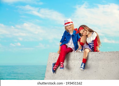 Fashion Kids Resting On The Sea . Vacation, Friendship, Fashionable Concept.