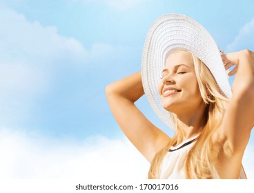 Fashion And Lifestyle Concept - Beautiful Woman In Hat Enjoying Summer Outdoors