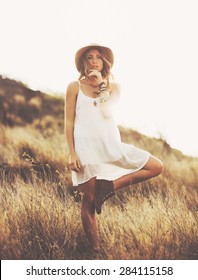 Fashion Lifestyle. Fashion Portrait Of Beautiful Young Woman Outdoors. Soft Warm Vintage Color Tone. Artsy Bohemian Style.